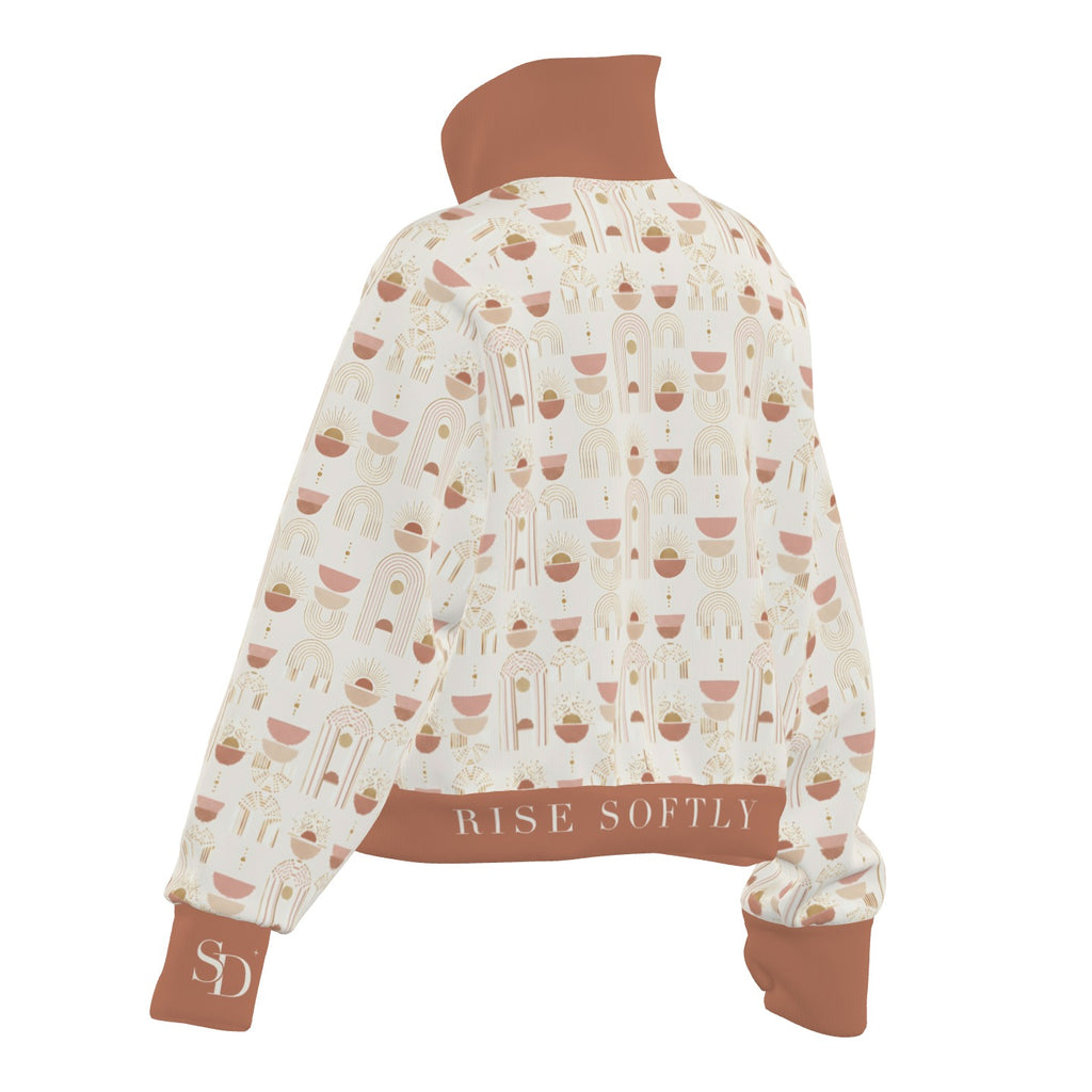 Sunrise Arches half-zip, back view with RISE SOFTLY on the hem and SD on the cuff